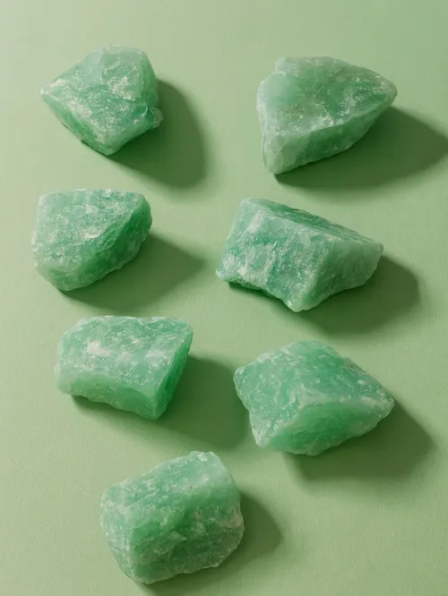 Microscopic comparison highlighting aventurine's glitter particles and jade's fibrous texture